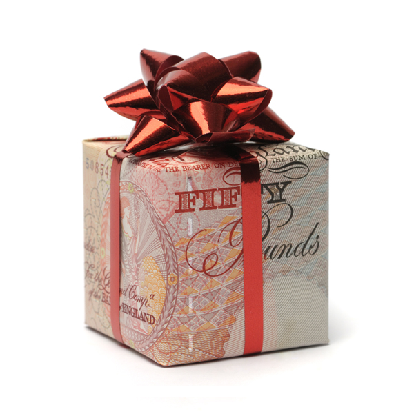 Gift box wrapped in an English pound with a red bow